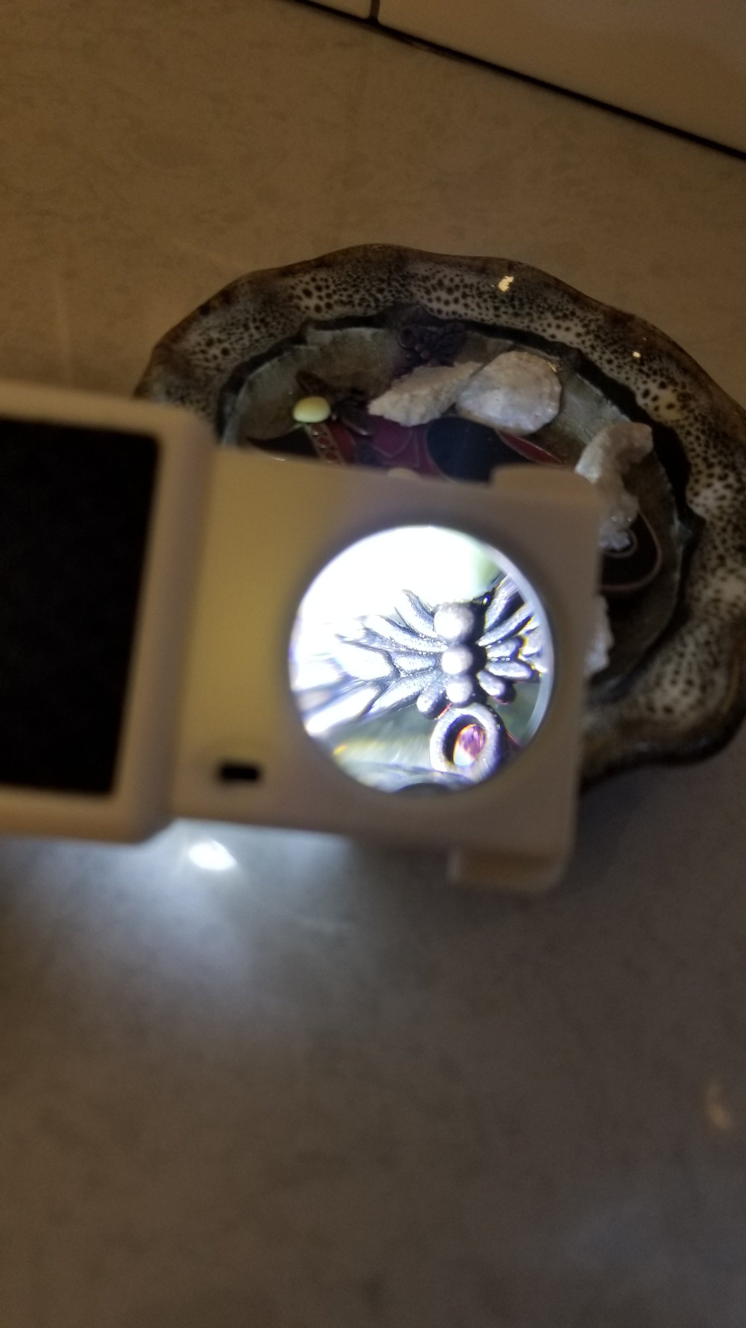 Small magnifier with light making jewelry larger and brighter to see. Magnifier pulls out of small tool. Available through National Supply Company LLC. 