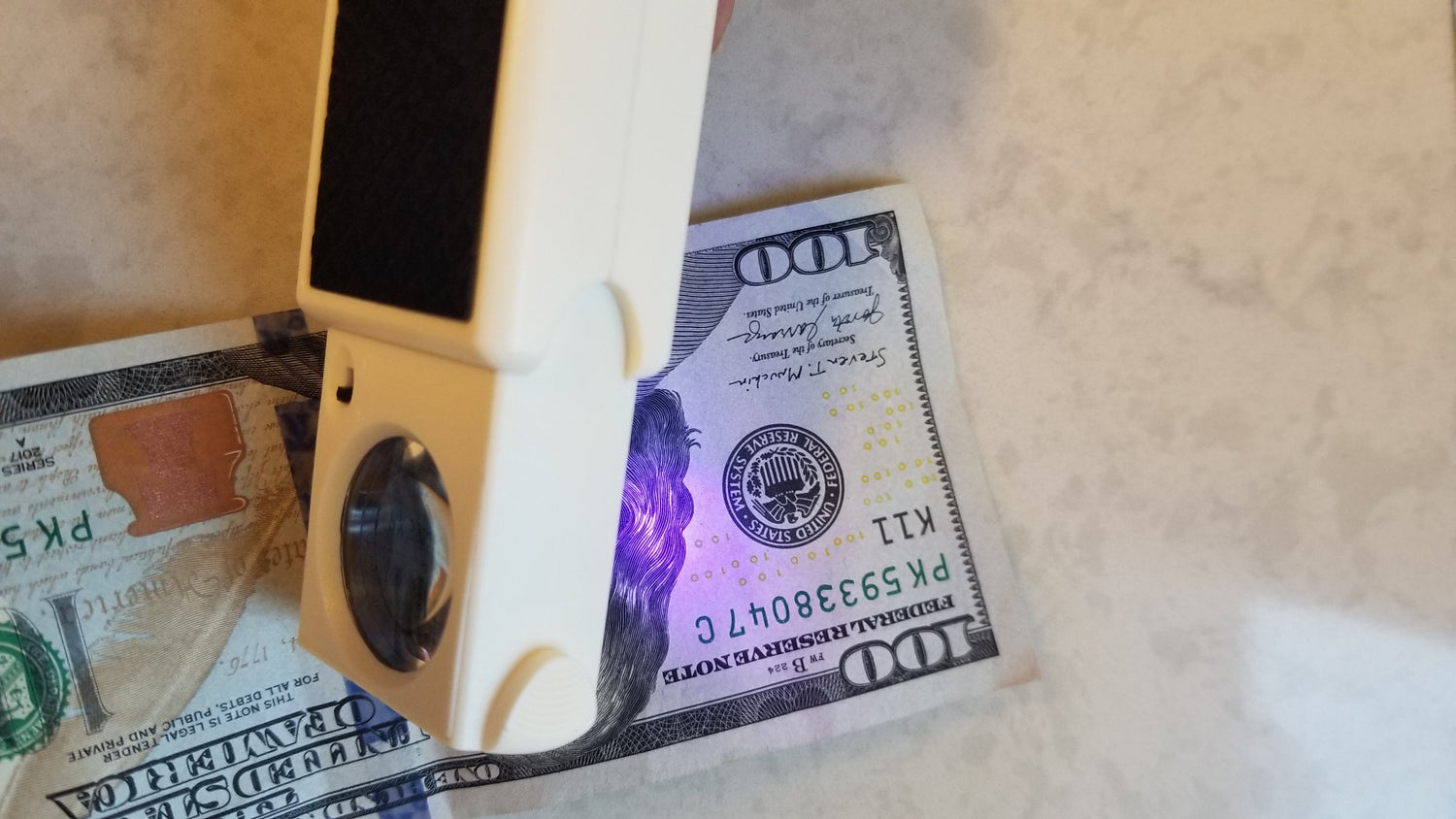 Counterfeit Detector with magnifier that pulls out when needed. Bright white or UV type lights for multiple uses including money legitimacy. At NSC LLC a small business. 