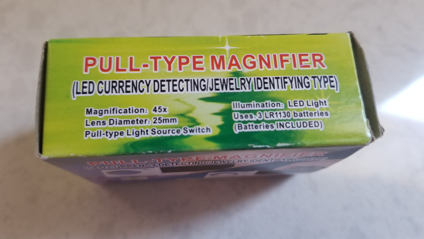 Pull Type Magnifier with LED Light for Money Detection and Jewelry Identification side panel of box. Side panel displays Magnification 45x, Lens Diameter 25mm, Light Source Switch, Illumination LED Light, and Batteries Included LR1130 batteries. Please visit product page at NSC LLC for more information.